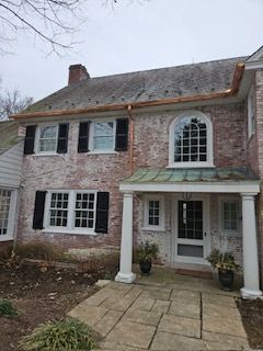 A Large Brick House With A Copper Gutter And A Porch — Lititz, PA — Trailside Spouting, LLC