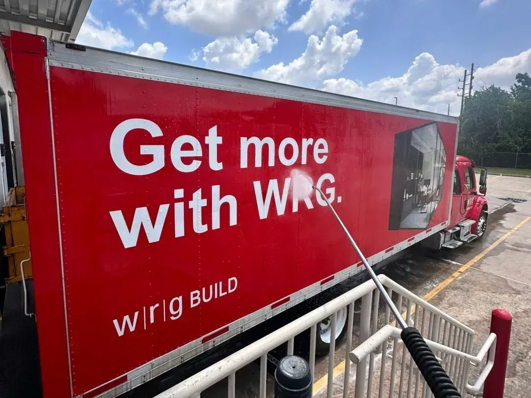 Red Wrig Build truck trailer with slogan “Get more with WRG” parked outdoors