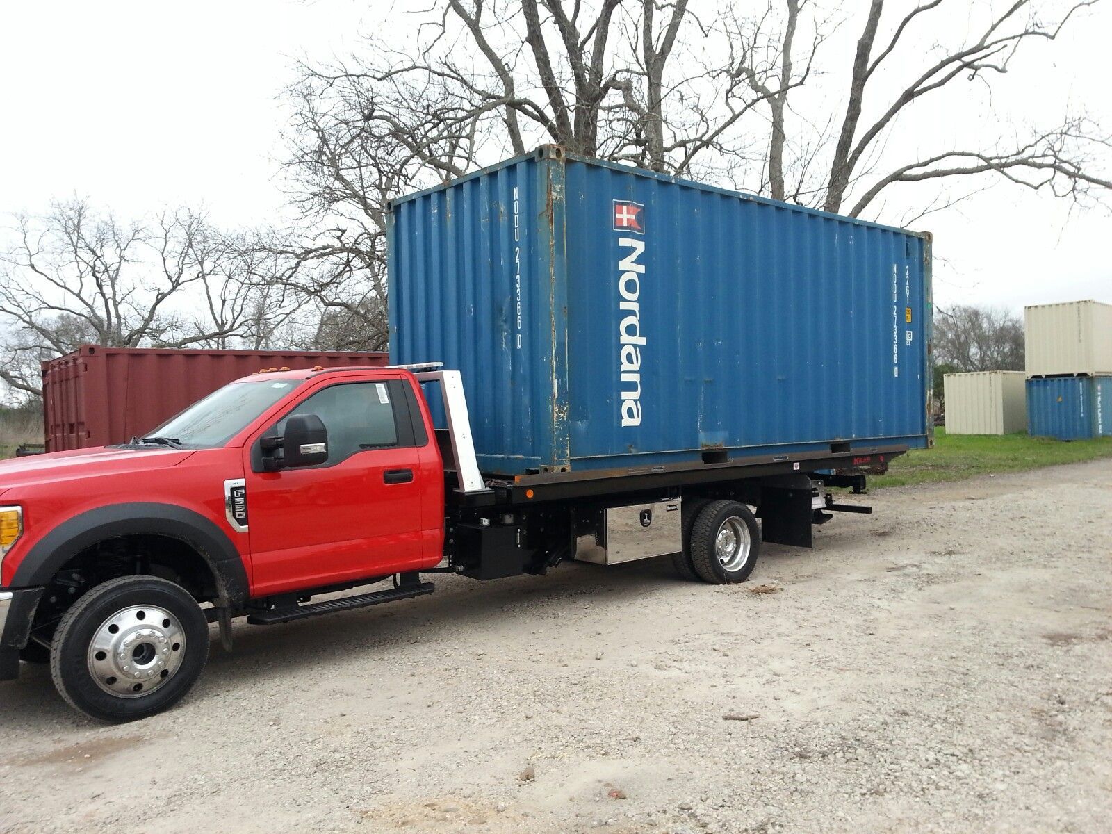 White shipping container with double doors, shown at an angle on a plain background