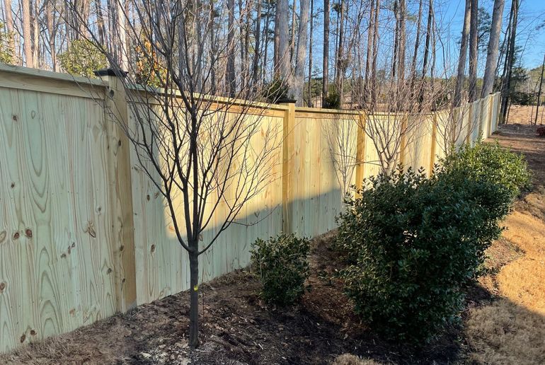 New wooden fence at garden of house