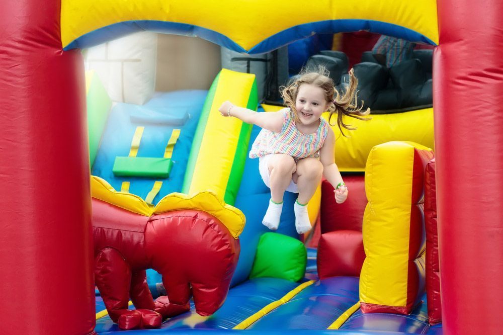 Kids Jumping On Colourful Inflatable — AMP Amusements In Gladstone, QLD