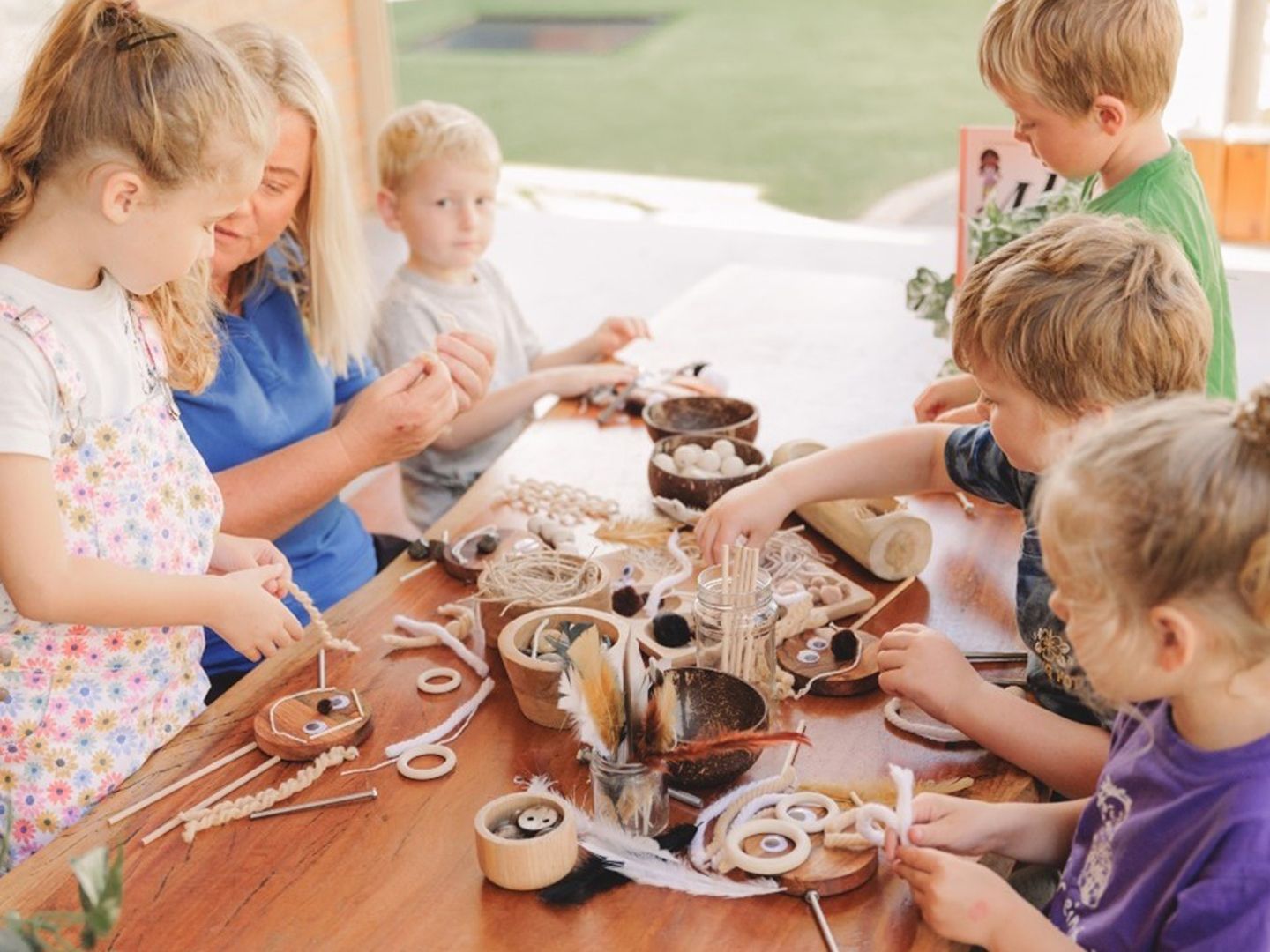 Children Are Sitting Around a Table Making Crafts — Shell Heights, NSW — Junior Einstein A Group of Children Are Sitting Around a Table Making Crafts — Shell Heights, NSW — Junior Einstein