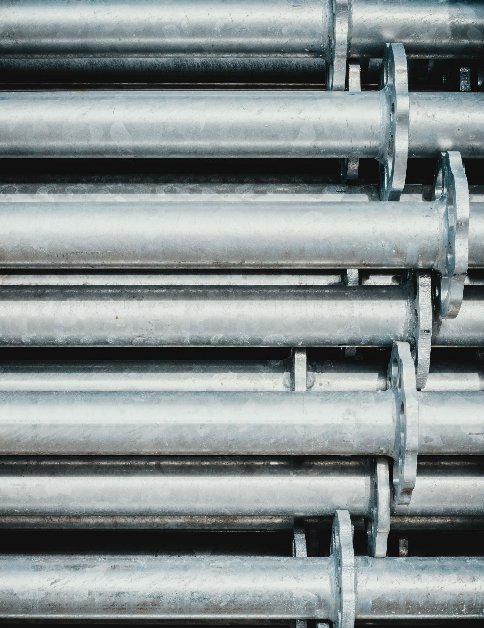 A close up of a stack of metal pipes.