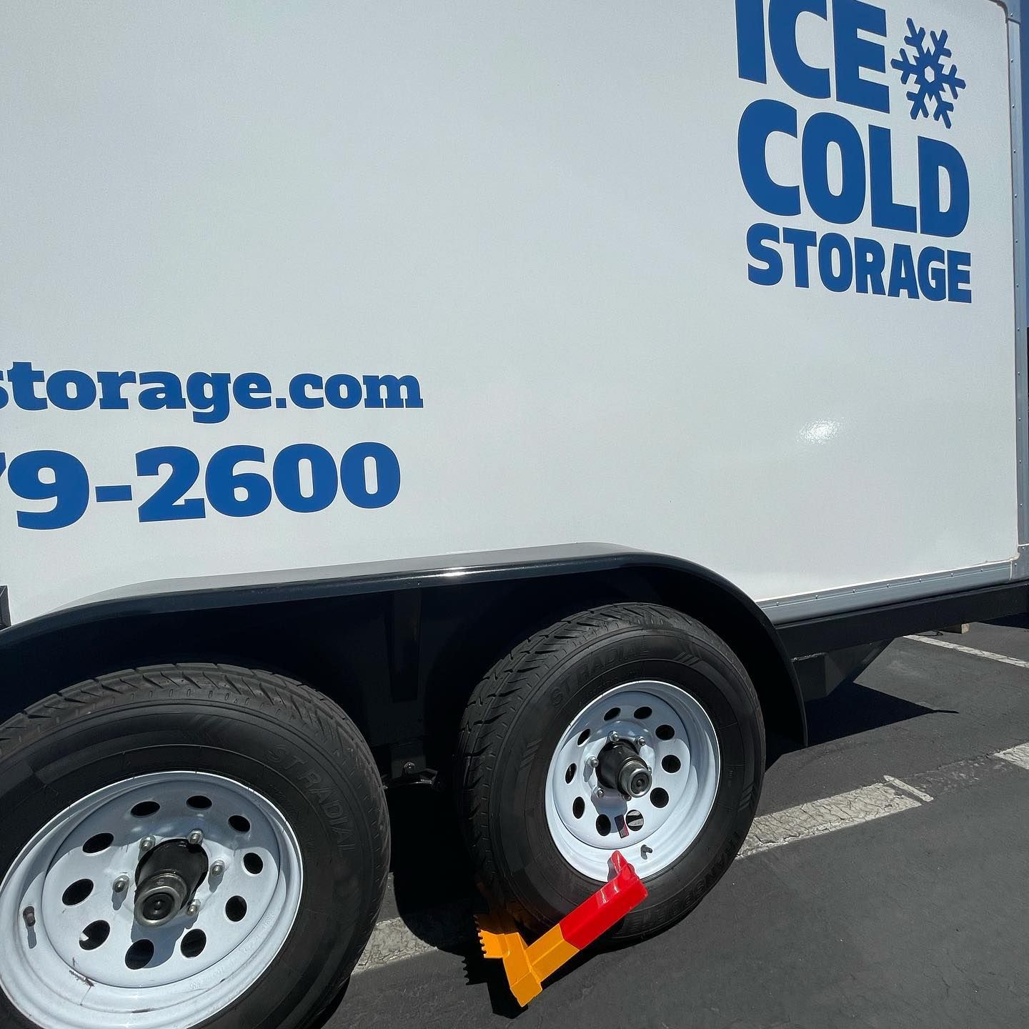 A white trailer that says ice cold storage on it