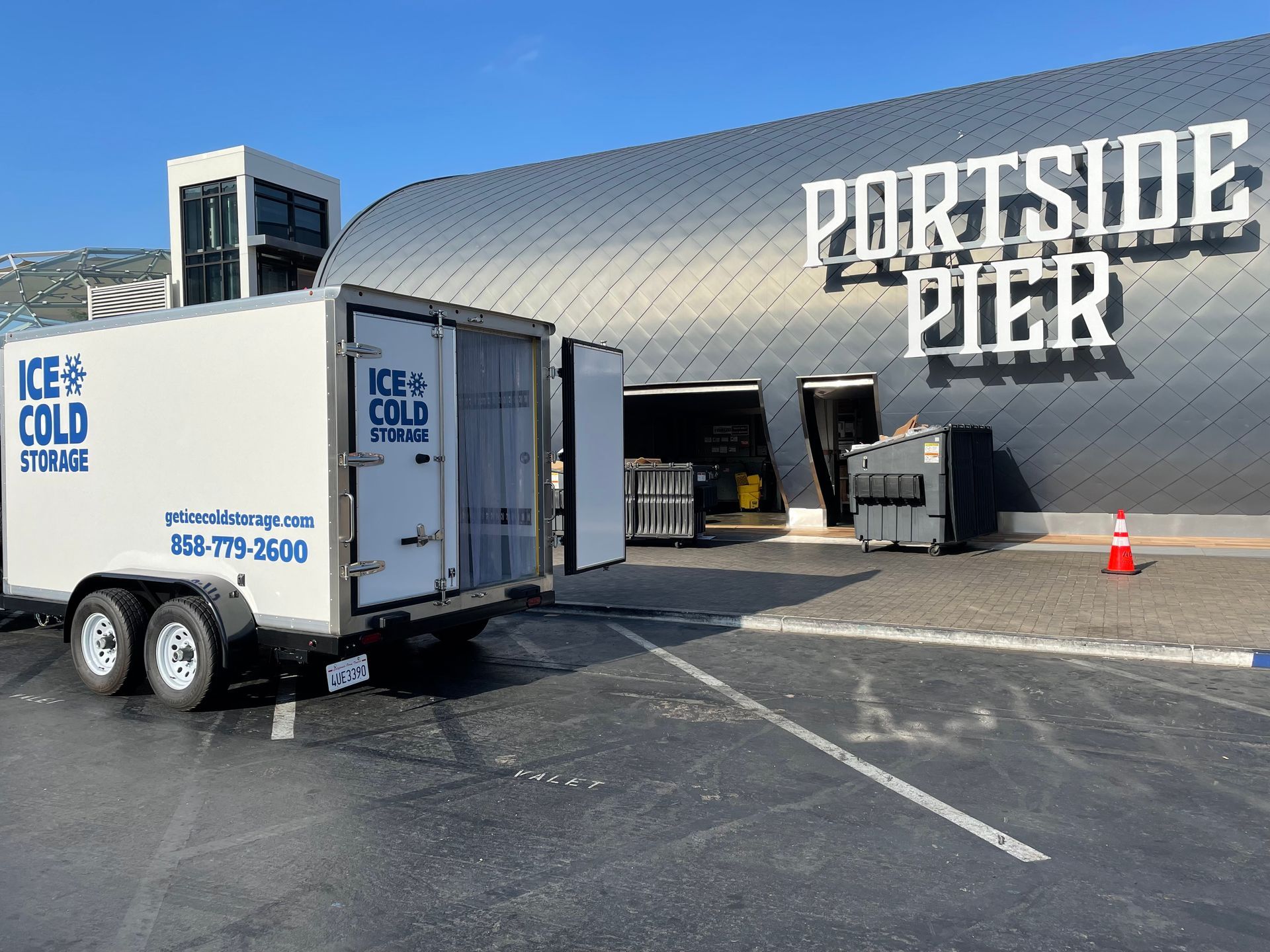 A trailer is parked in front of a building that says portside pier