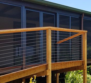 A door with a wooden walk way leading up to it — Superior Windows & Doors Taree, NSW