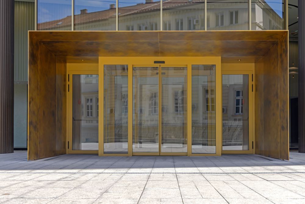 The Entrance to a Building With a Wooden Roof and Sliding Glass Doors — Superior Windows & Doors Taree, NSW