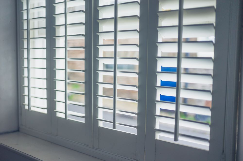 A Close Up of a Window With White Shutters on It — Superior Windows & Doors Taree, NSW