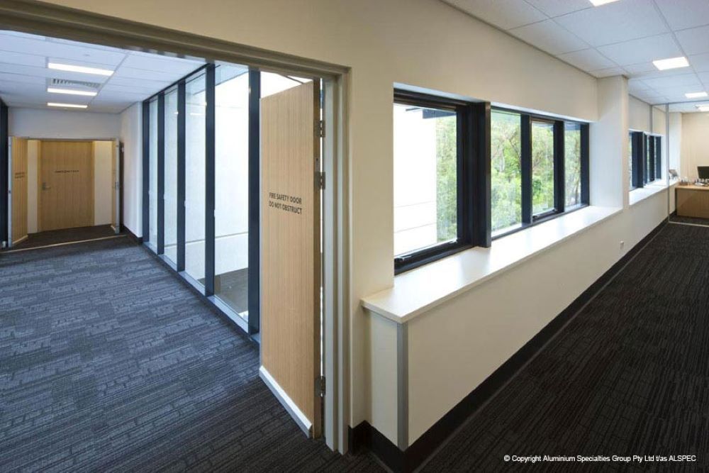 A Long Hallway With a Lot of Windows and Doors — Superior Windows & Doors Taree, NSW