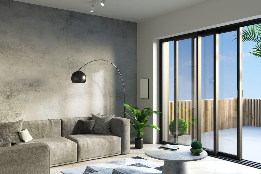 A Living Room With a Couch, Coffee Table, and Sliding Glass Doors — Superior Windows & Doors Taree, NSW