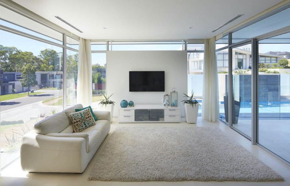 A Living Room With a White Couch and a Flat Screen TV — Superior Windows & Doors Taree, NSW