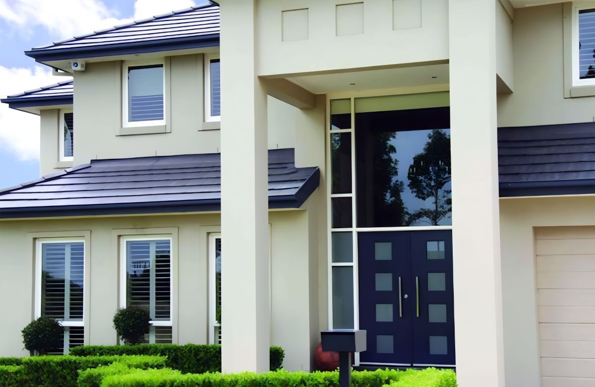 A House With a Lot of Windows and Plants in Front of It — Superior Windows & Doors Taree, NSW