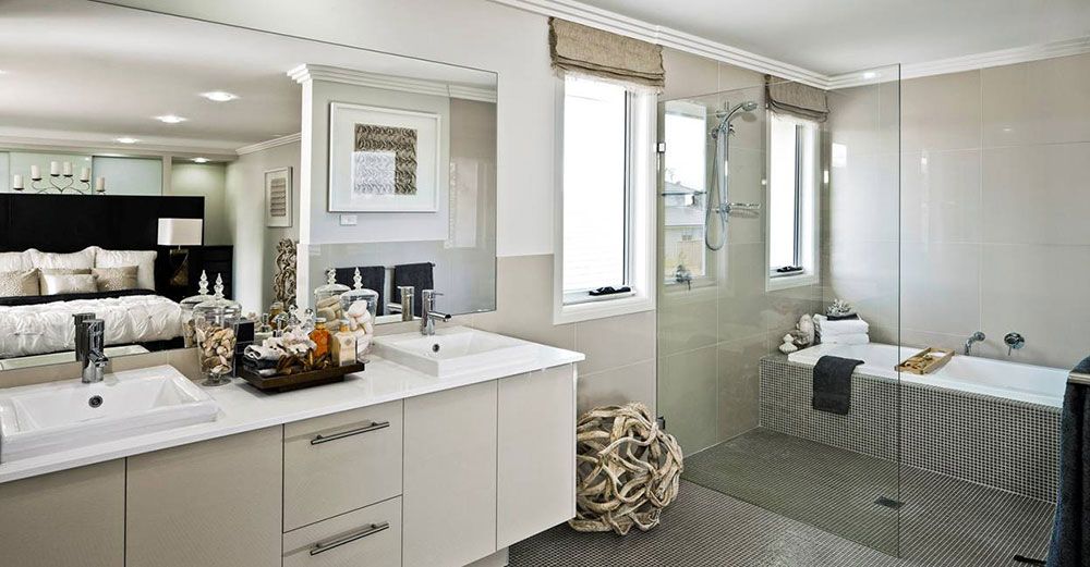 A bathroom with two sinks , a bathtub and a walk in shower — Superior Windows & Doors Taree, NSW