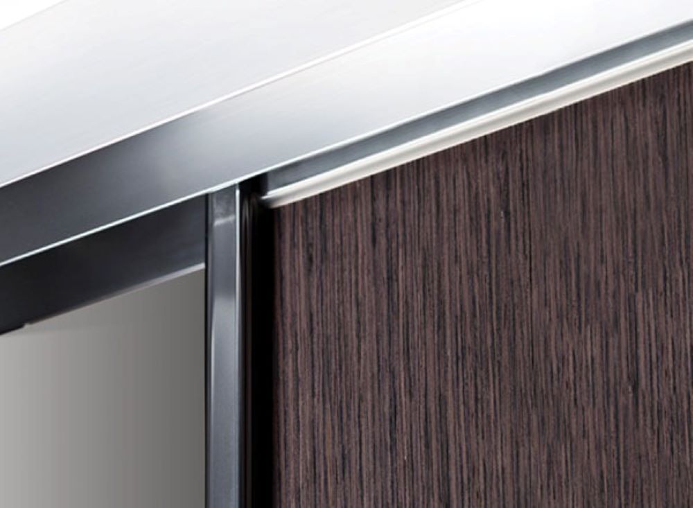 A Close Up of a Wooden Cabinet With a Metal Trim — Superior Windows & Doors Taree, NSW