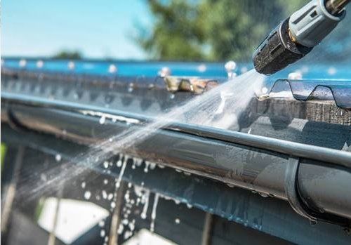 picture of a hose cleaning gutters