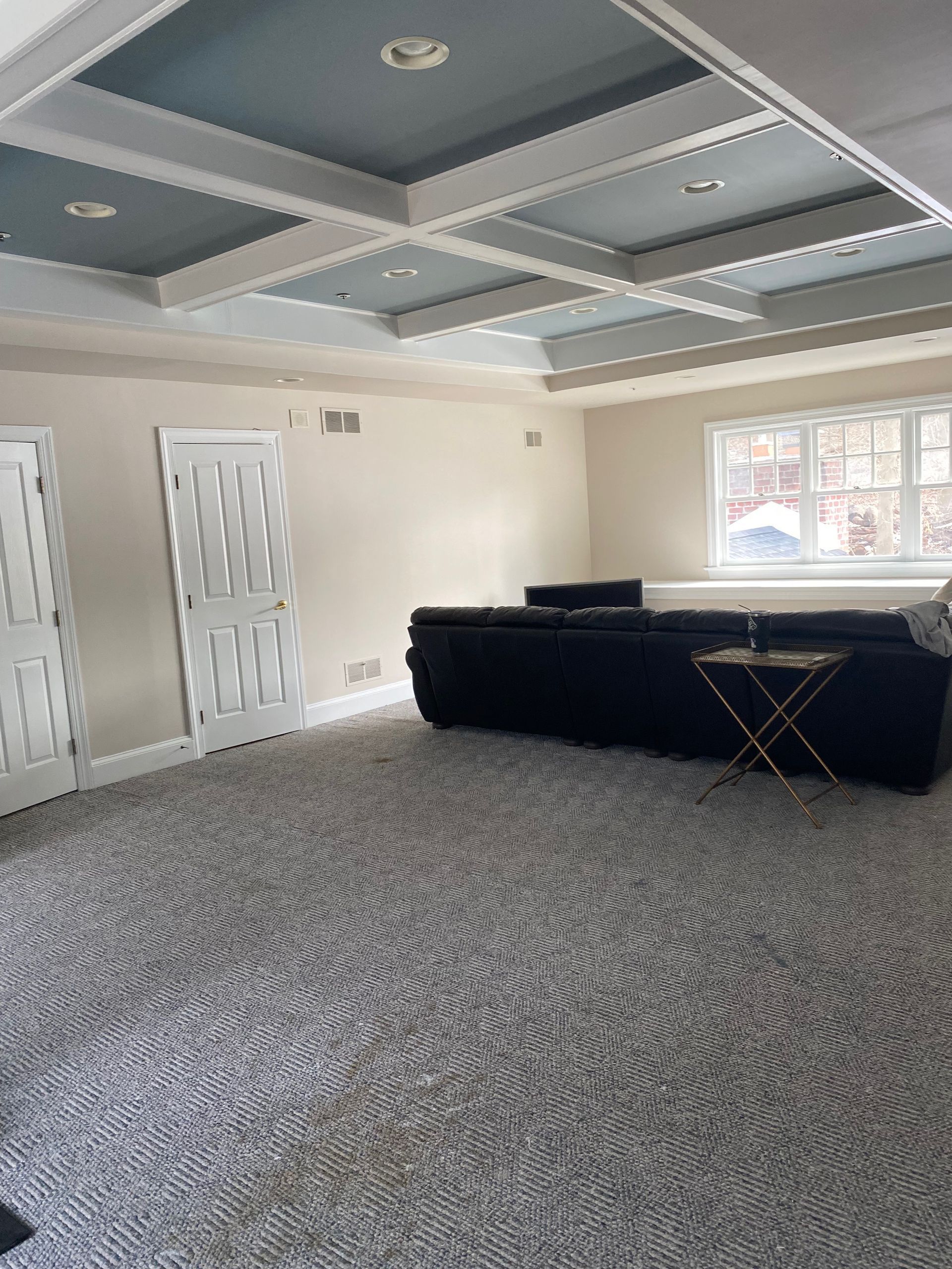 A living room with a couch and a table in it.