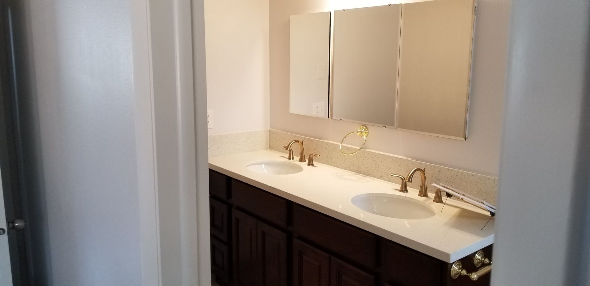 A bathroom with two sinks and a mirror.