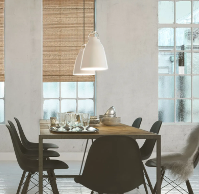 Dining room with table set for a meal, pendant lights, black chairs, and windows with blinds.