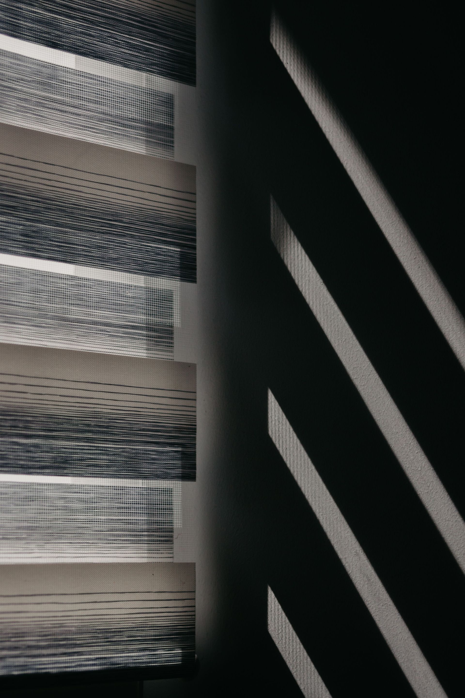 Abstract black-and-white striped pattern with diagonal light and shadow lines