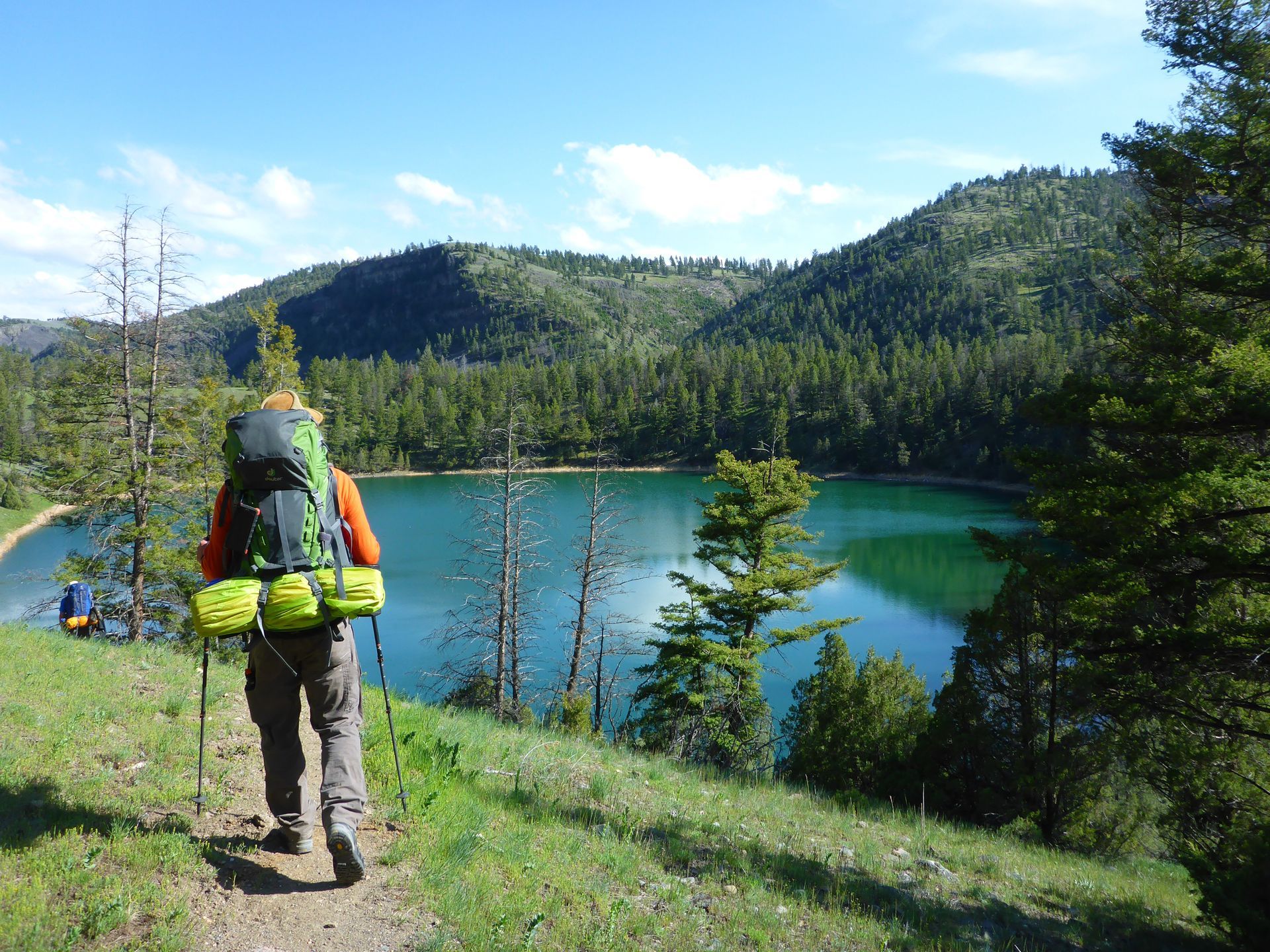 Backpackers hike past the emerald waters of Crevice Lake.