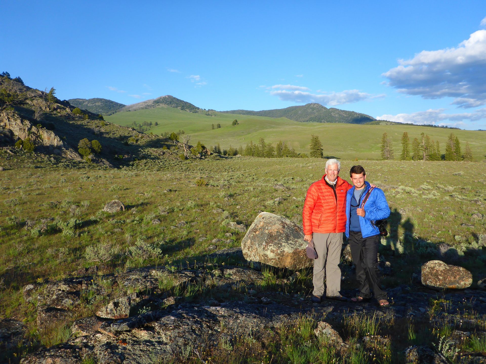 Backpackers enyoy a beautiful evening along Hellroaring Creek as the sun sets over the massive Buffalo Plateau.