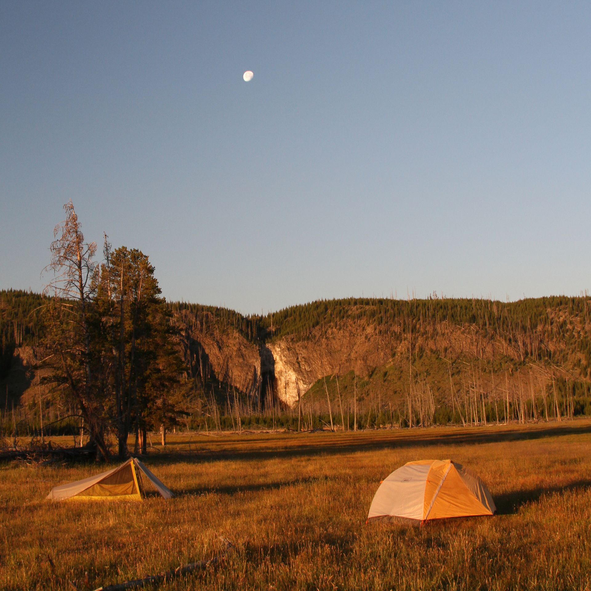 Fairy Falls, Yellowstone The moon rises over Fairy Falls as the morning sun casts a beautiful orange glow across the landscape.