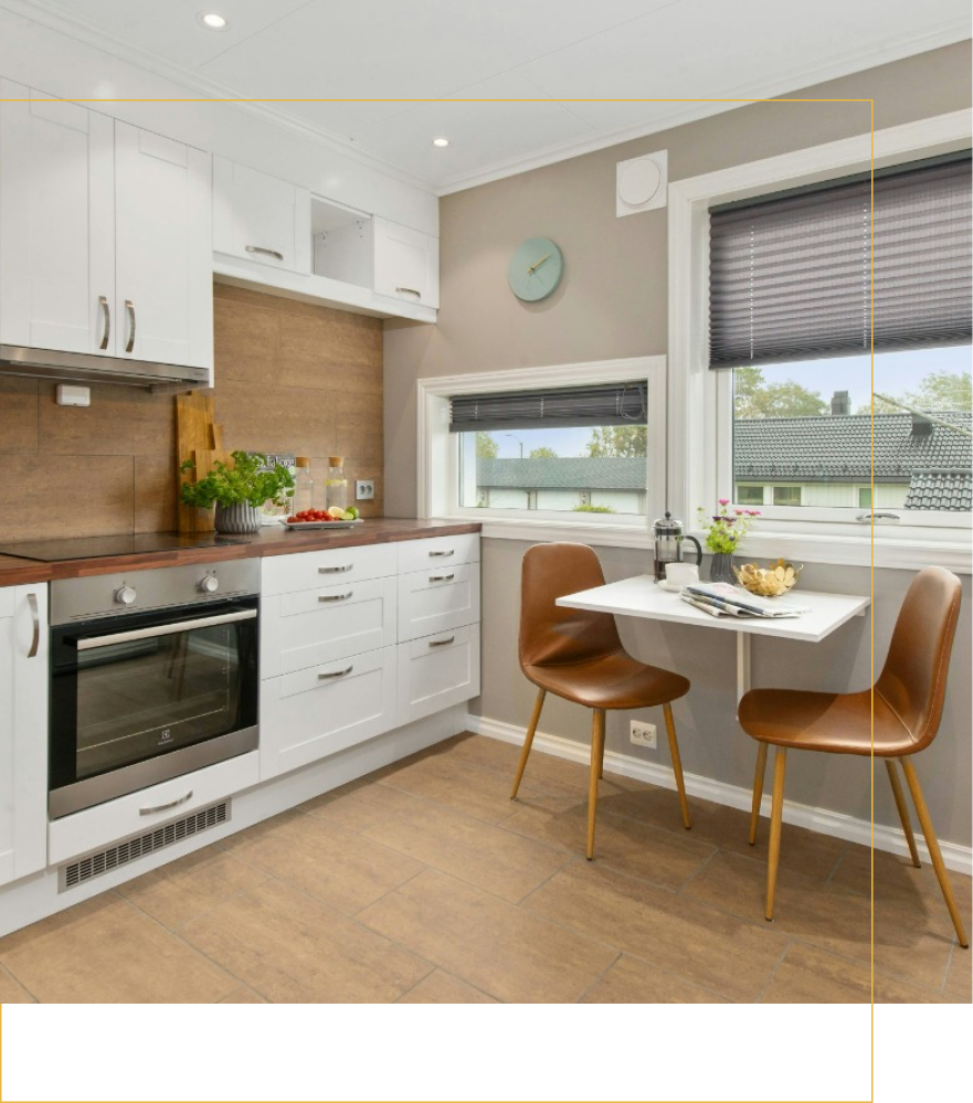 A kitchen with a table and chairs and a clock on the wall.