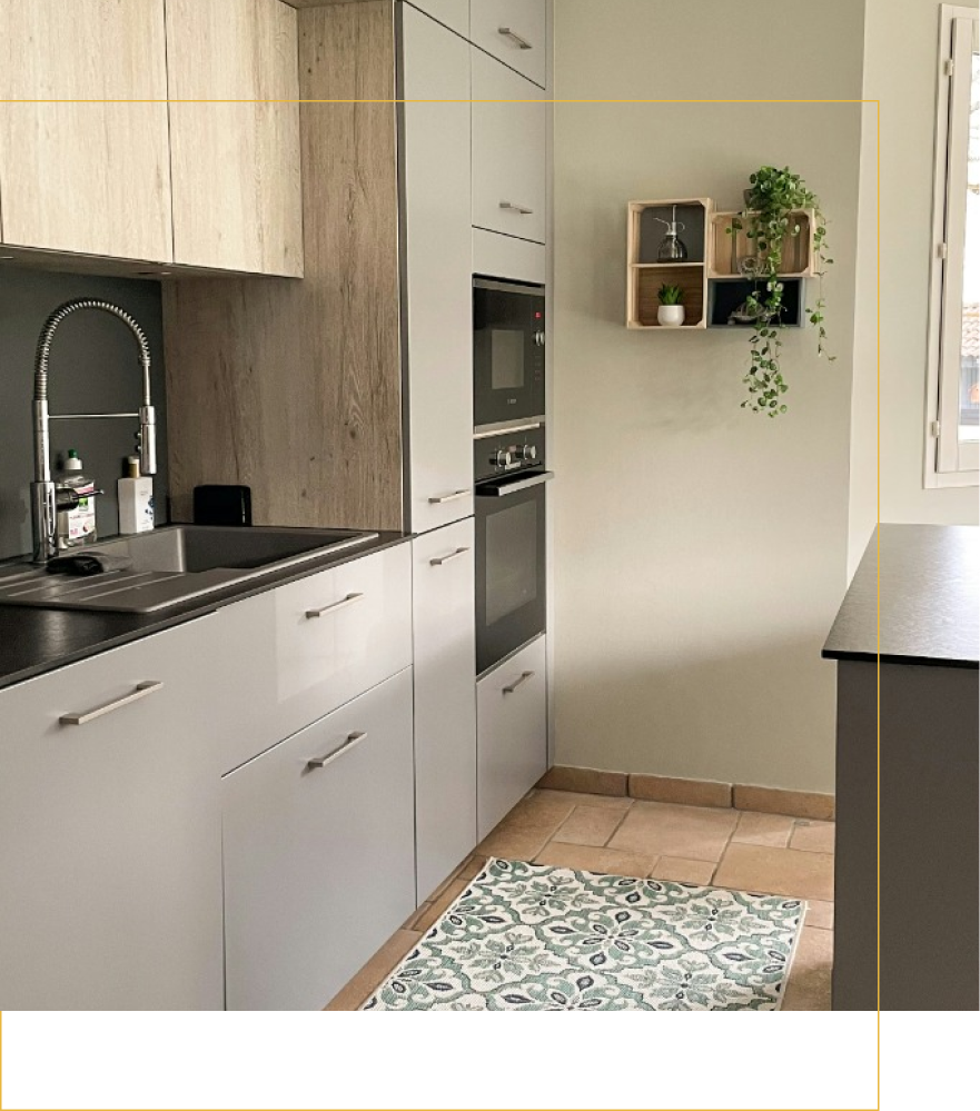 A kitchen with white cabinets , a sink , an oven , and a window.