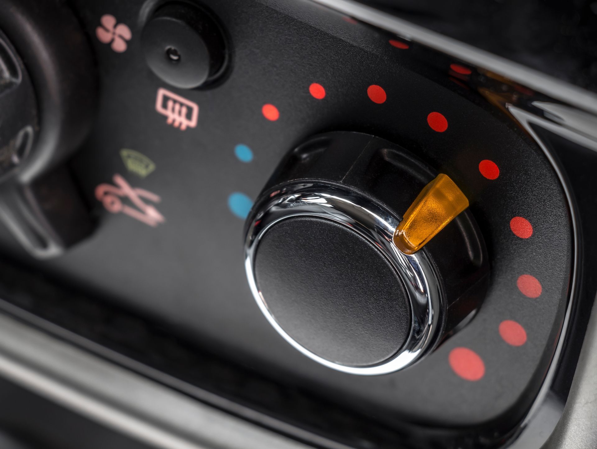 Car climate control dial with red and blue temperature markings and orange indicator | Cruz-N-Carz