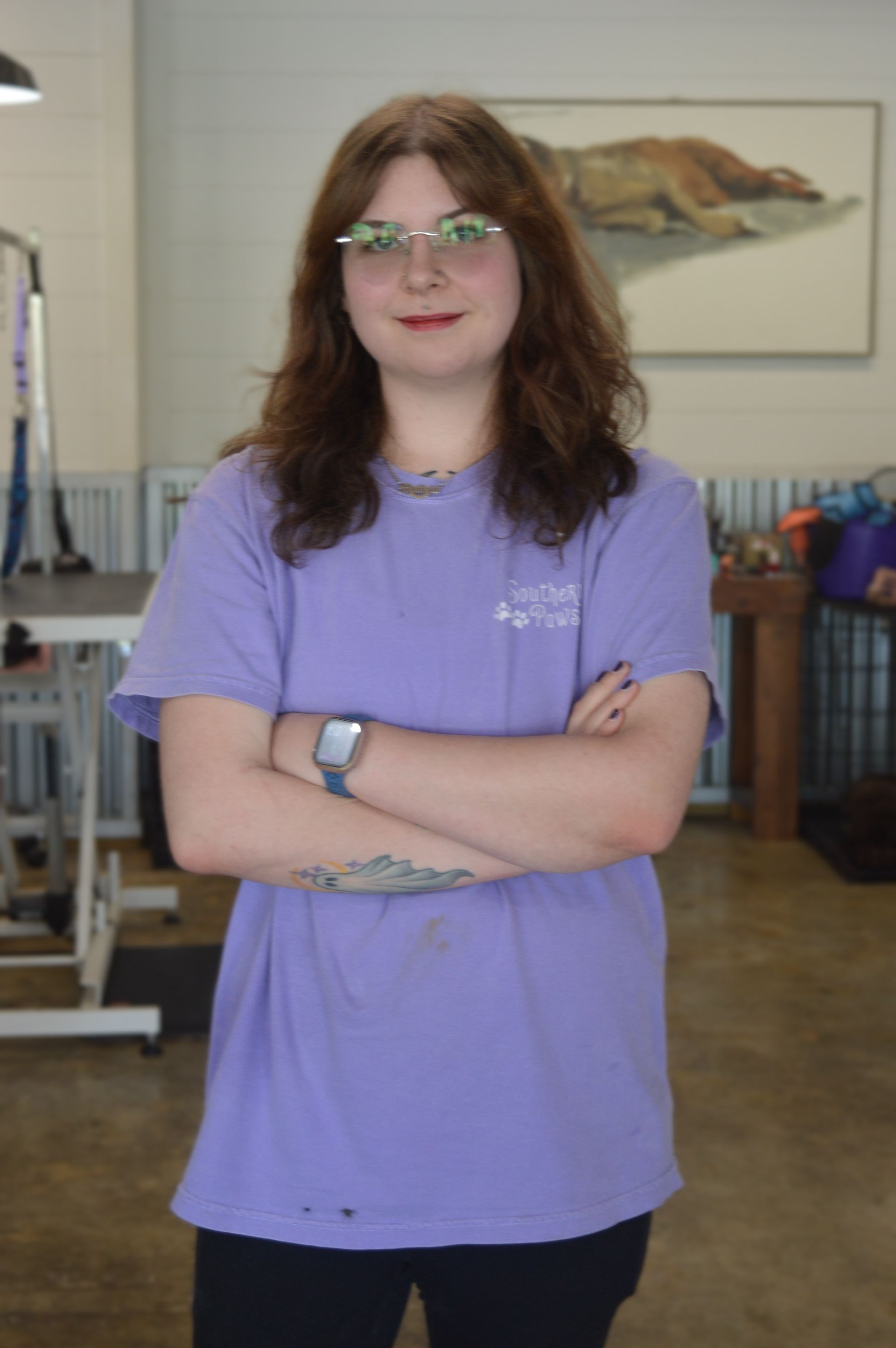 A young woman with long hair is wearing a green t-shirt and leggings.