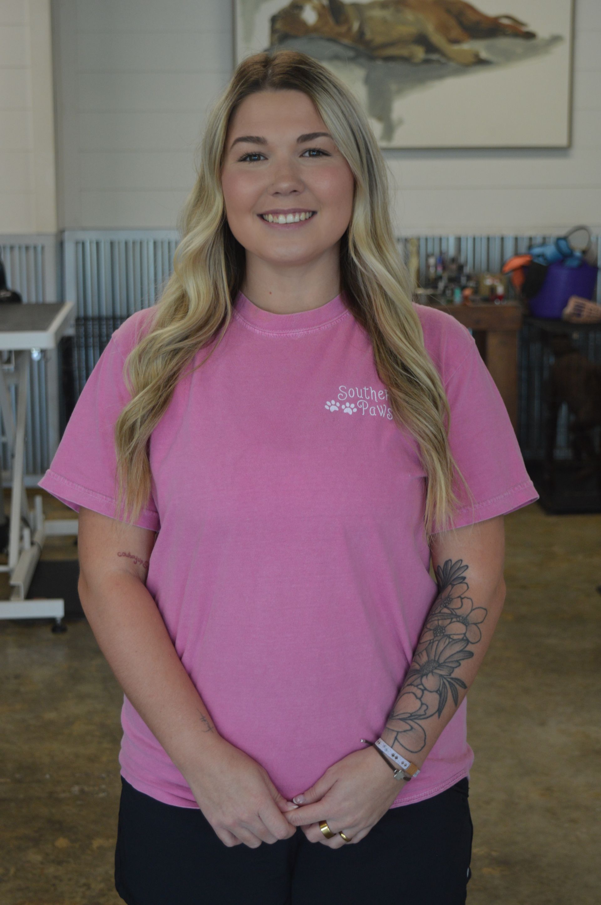 A young woman with long hair is wearing a green t-shirt and leggings.