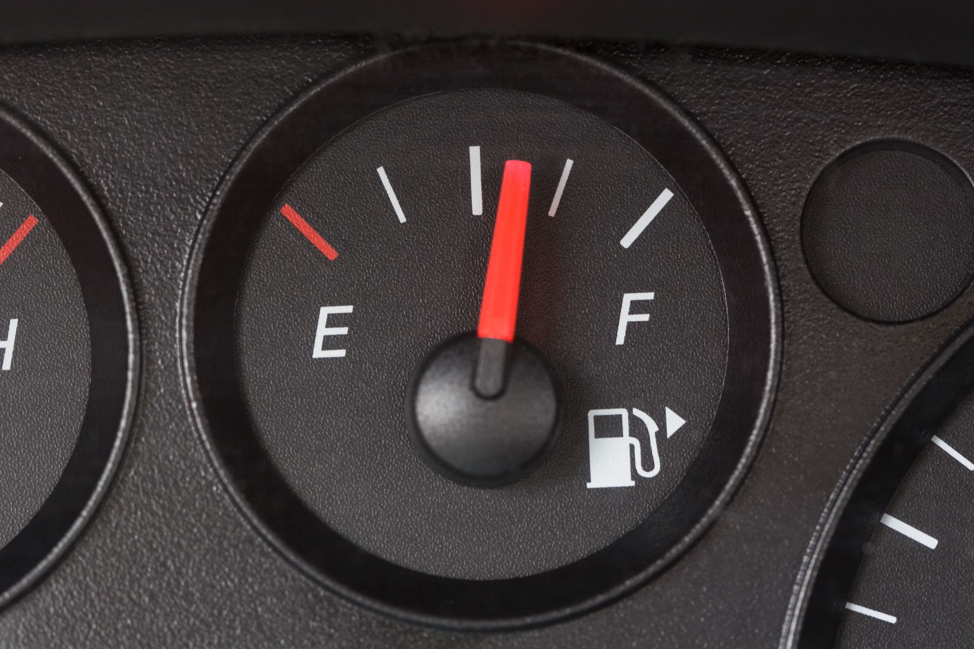 Fuel gauge needle points past half, nearing full tank.