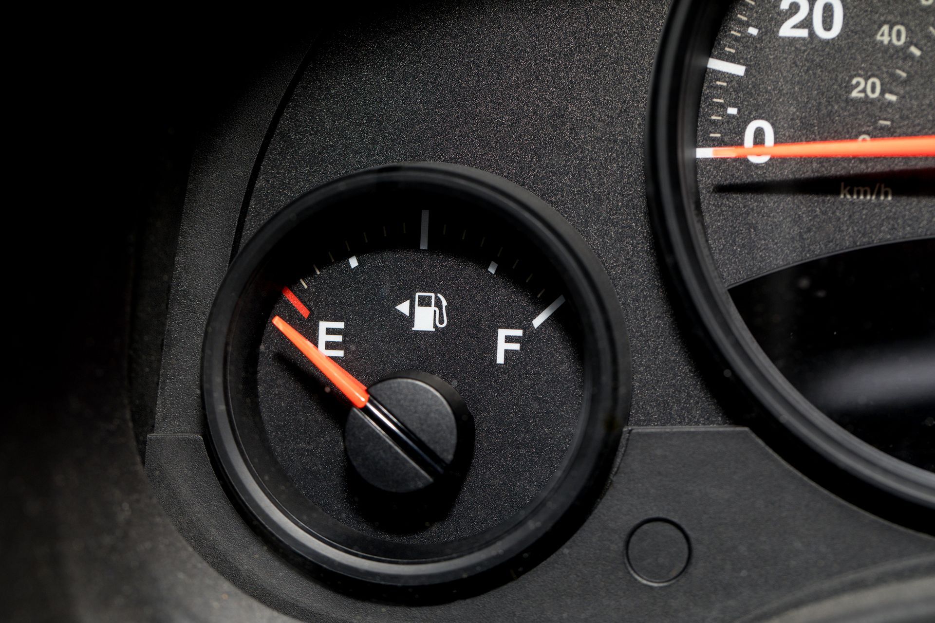 Low fuel guage shown in a car shot close