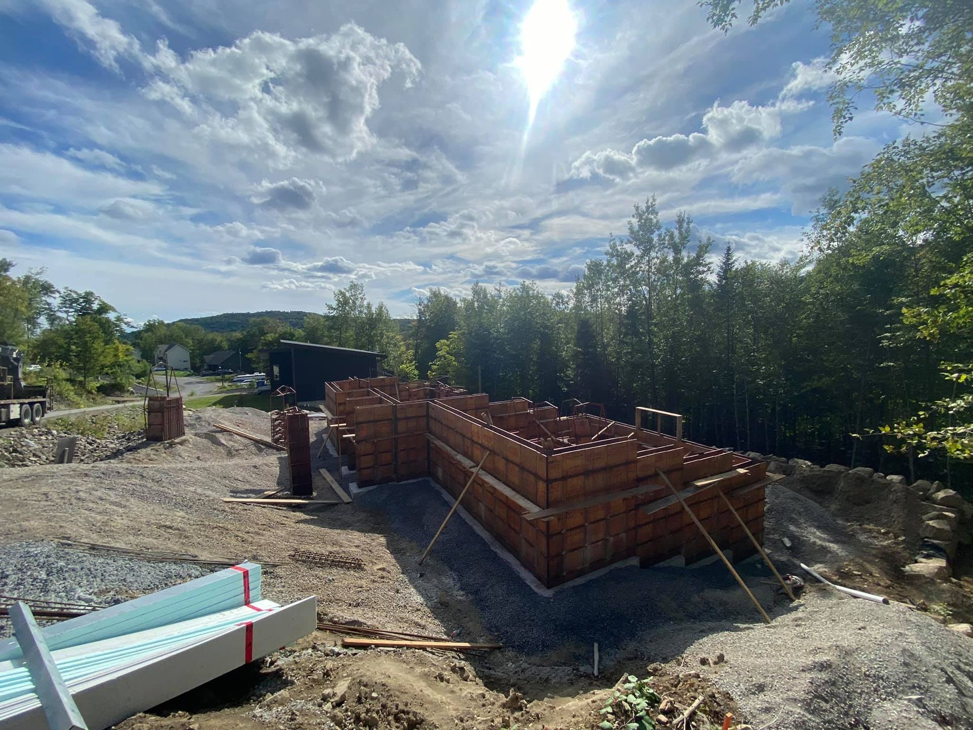 Le soleil brille à travers les nuages ​​au-dessus d'un chantier de construction.
