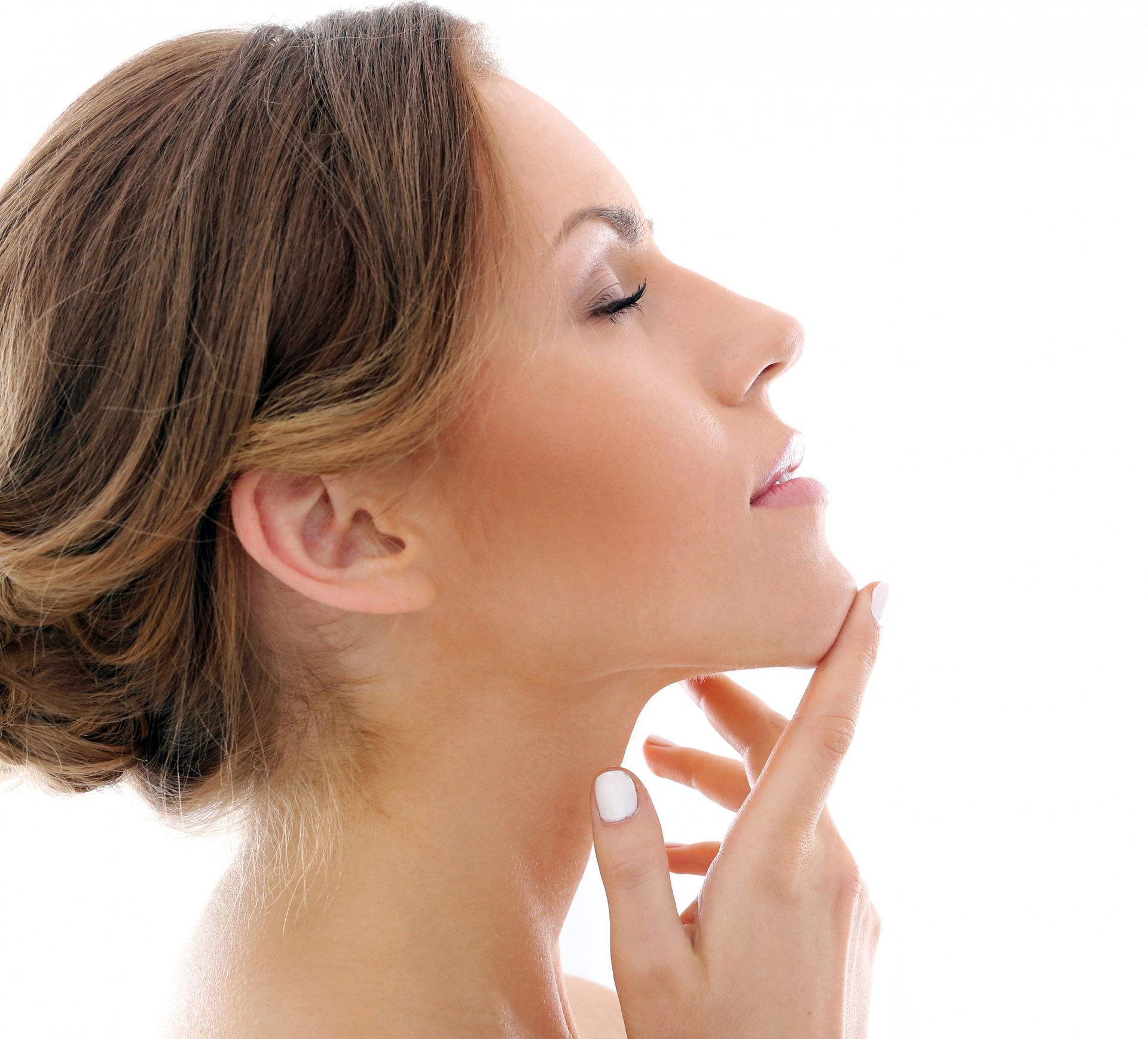 A close up of a woman 's face with her hand on her chin.