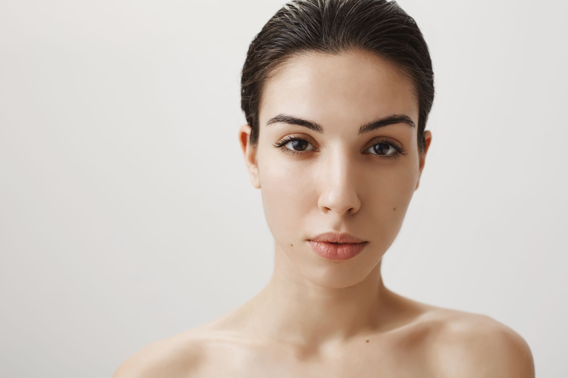 a close up of a woman 's face with a white background