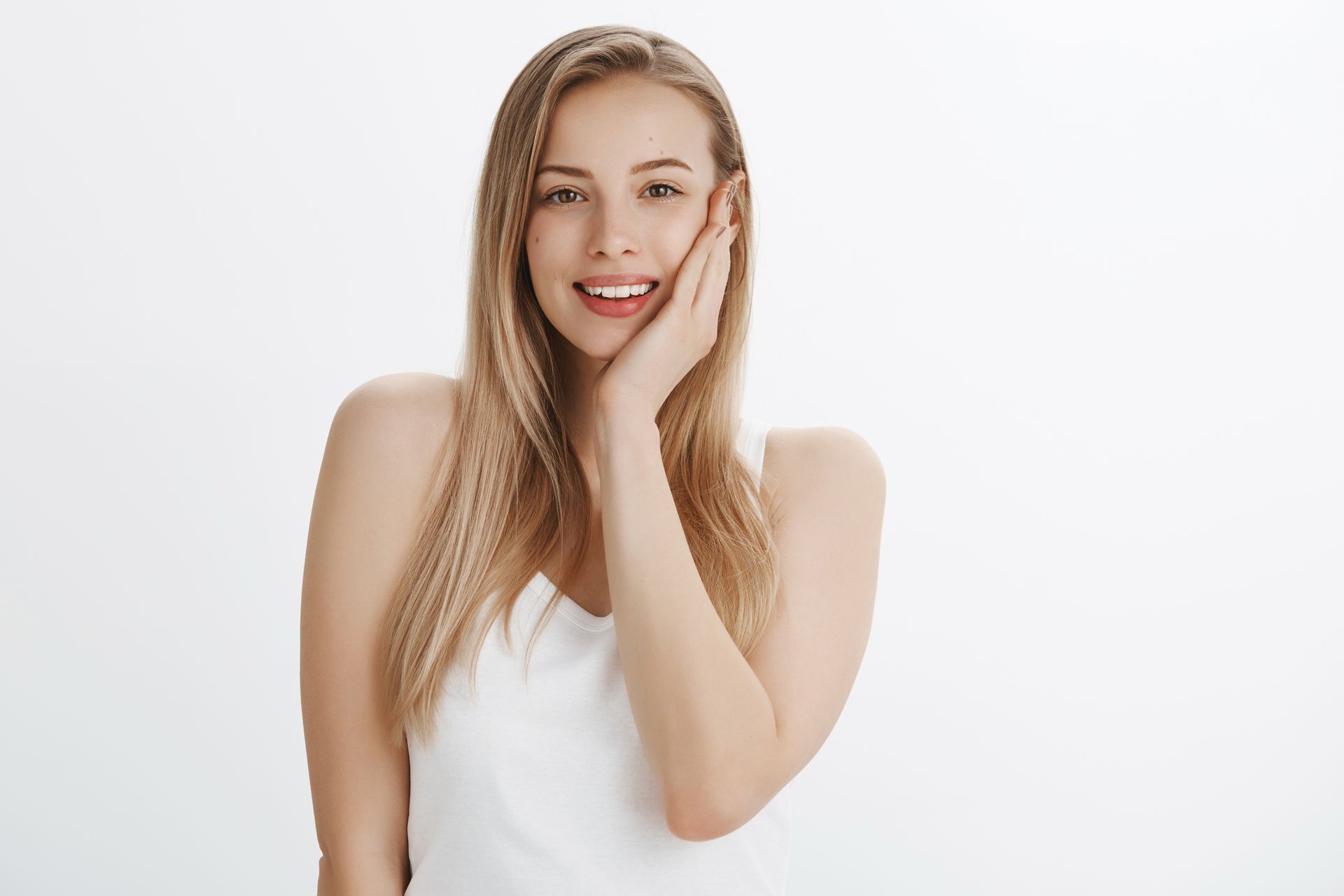 a woman with red nails is pointing to her smile