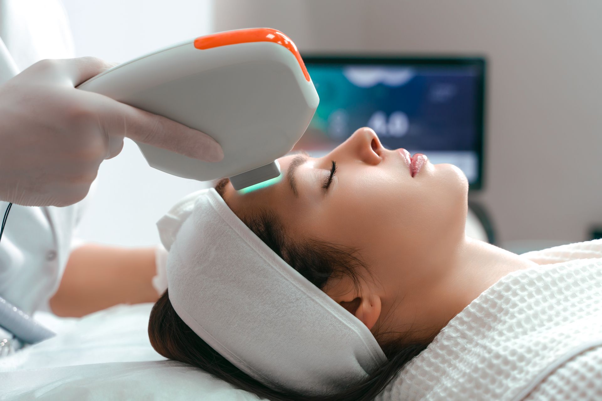 a woman is getting a laser treatment on her face