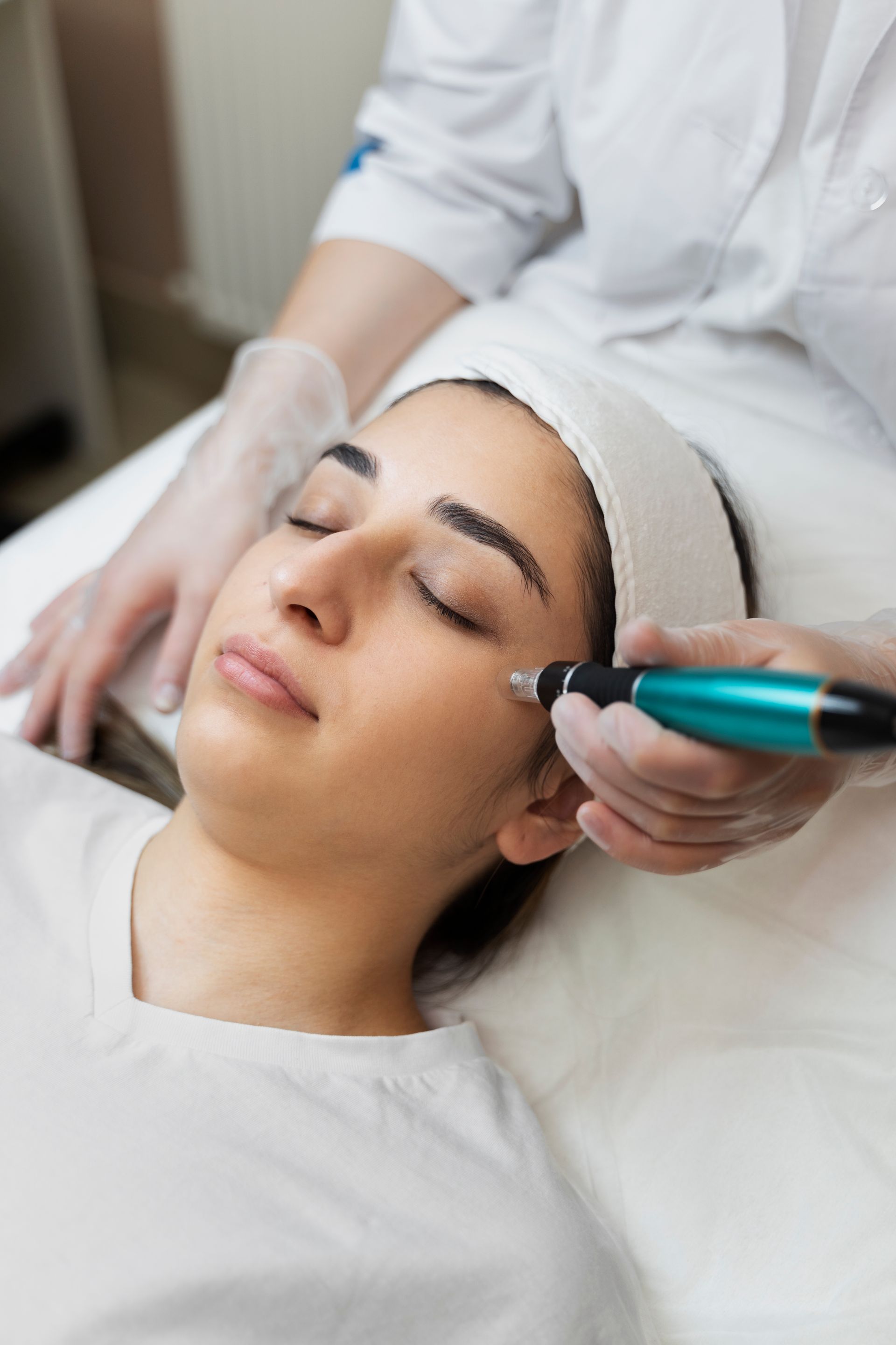 a woman is getting a treatment on her face