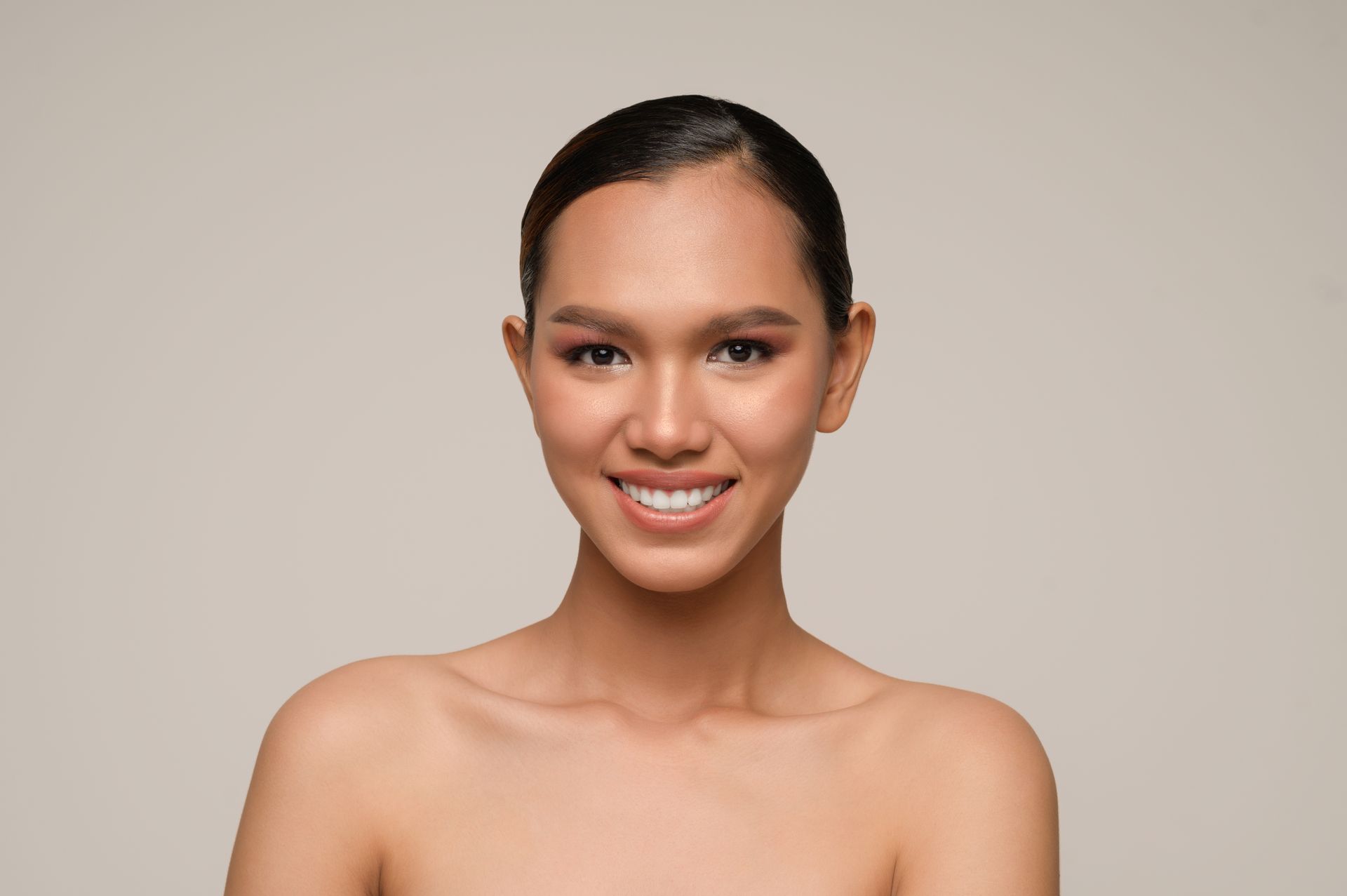 The woman is smiling and looking at the camera.