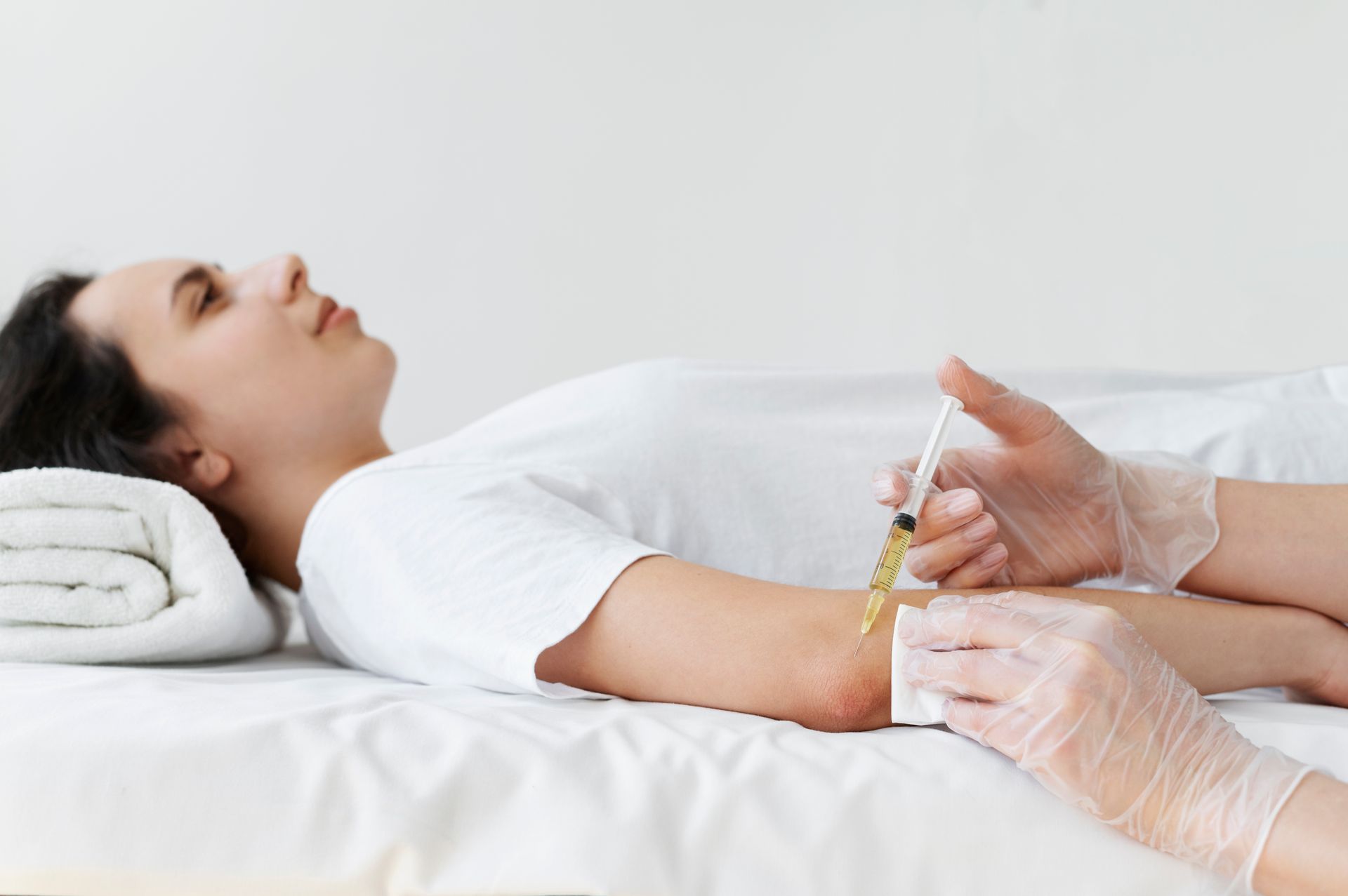 a woman is getting an injection in her elbow