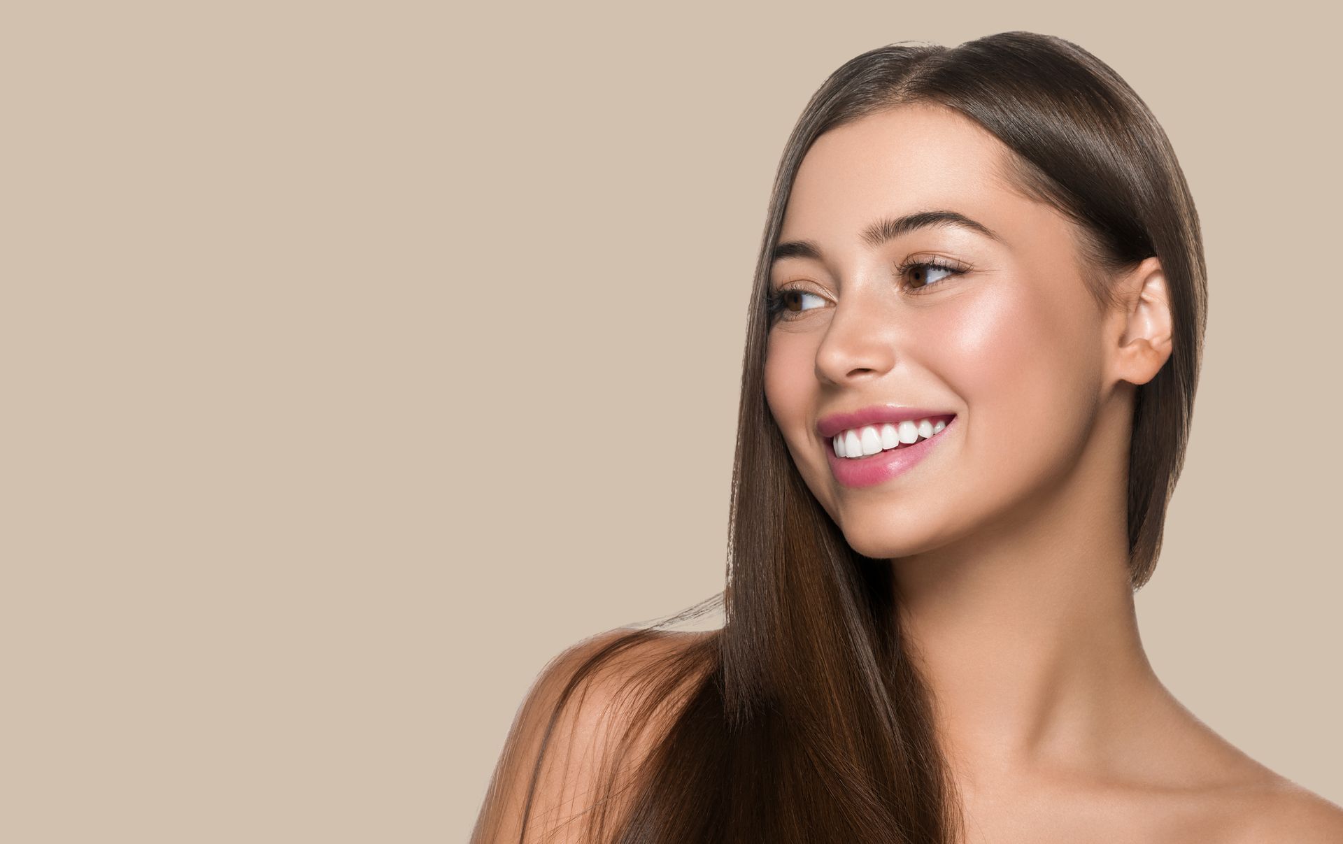 a woman with long hair is smiling and looking to the side