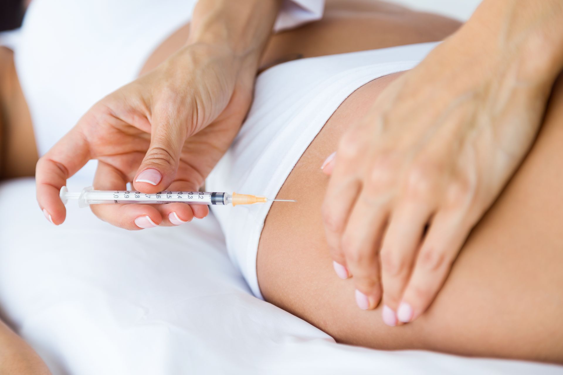 a woman is getting an injection with a syringe