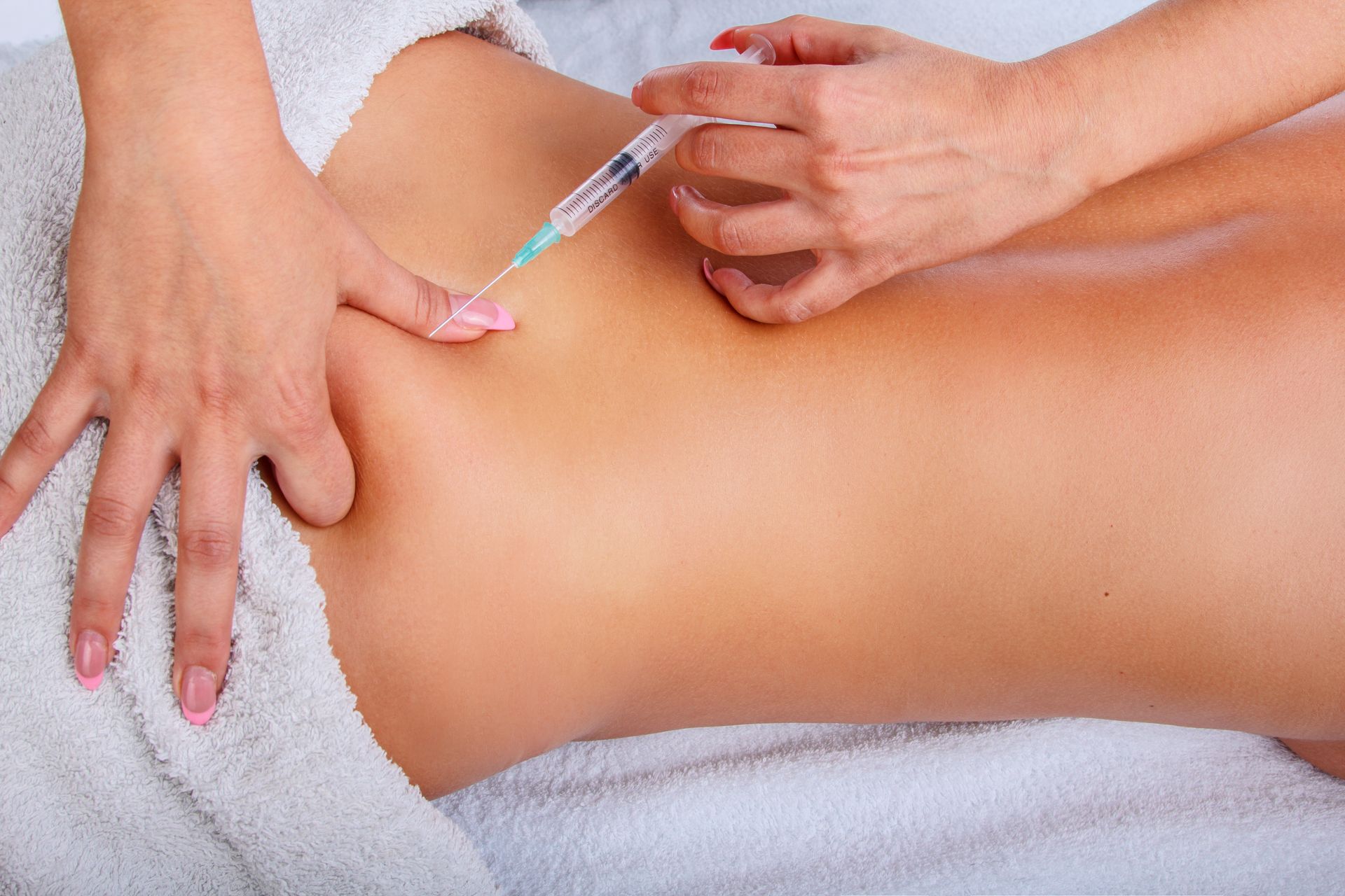a woman is getting an injection in her back