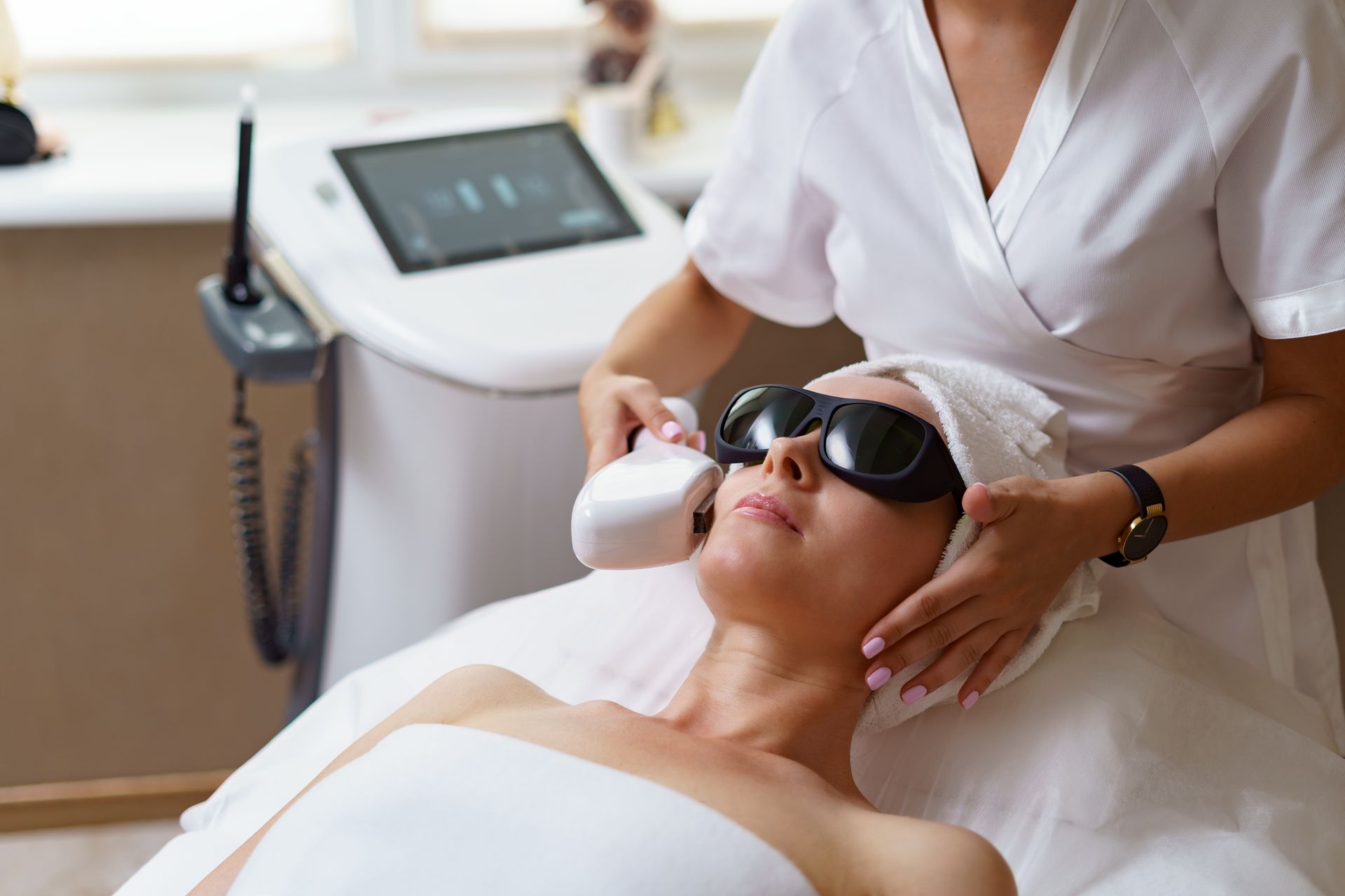 a woman is getting a laser treatment on her face