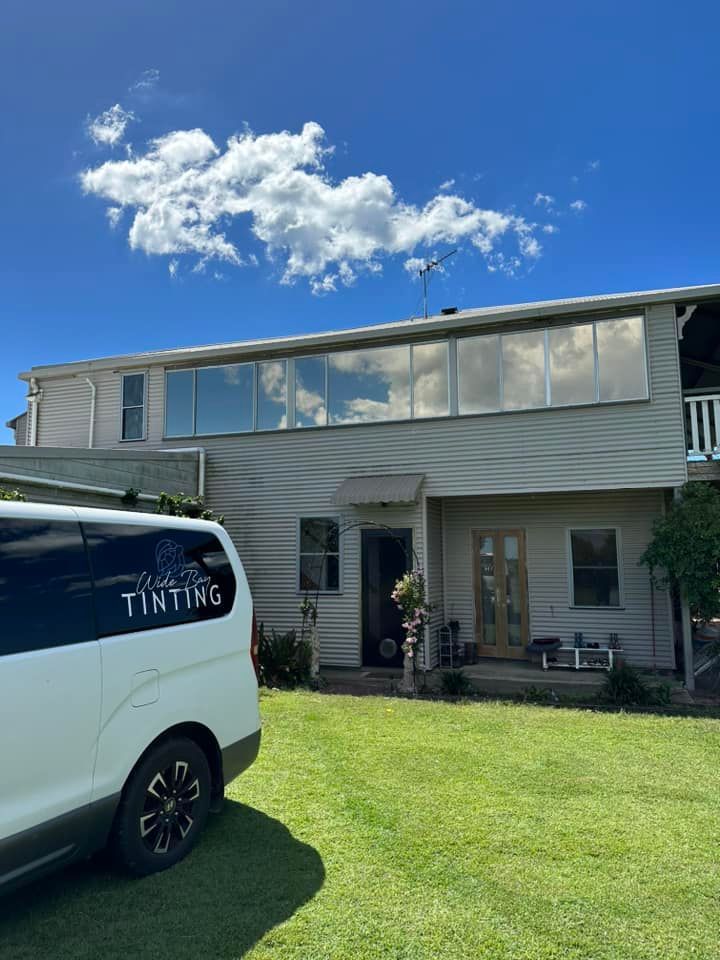 White Van Parked in Front of a House With Tinted Windows — Wide Bay Tinting in Bargara, QLD