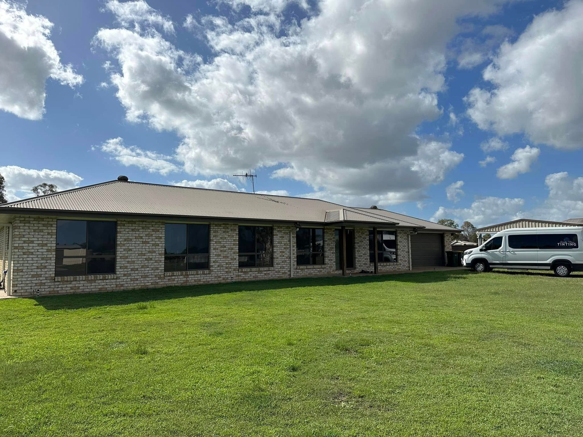 Single-story brick house with dark windows, a brown roof — Wide Bay Tinting in Kensington, QLD