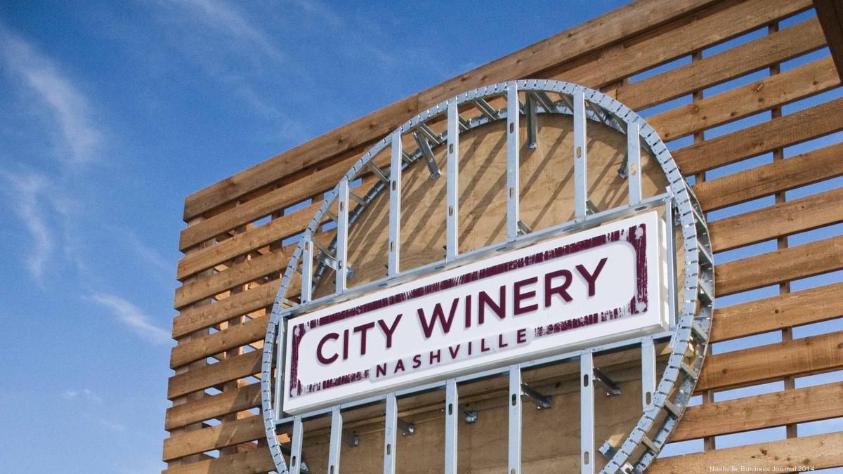 City Winery sign on a wooden wall against a blue sky