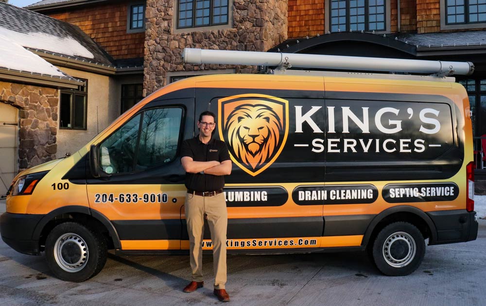 Man standing in front of King's Services van with lion logo. Services: plumbing, drain cleaning, septic service.