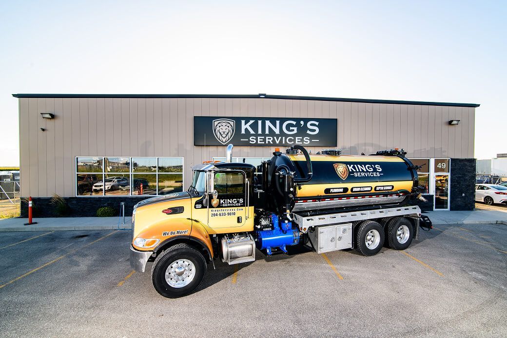 King's Services septic pumping truck parked outside company headquarters providing septic tank pumping services in Winnipeg for residential homes.